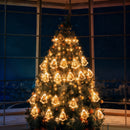 Curtain of bright Christmas lights with 10 miniature Christmas figures.