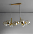 Bring timeless elegance to your home with the Modern Bubble Glass Chandelier – Copper Linear Pendant Light, a luxurious modern lighting fixture designed to elevate large living rooms, dining areas, staircases, and contemporary upscale interiors. Featuring high-transparency bubble glass shades combined with a premium forged copper structure, this chandelier blends artistic design with powerful LED illumination. Each bubble glass sphere refracts light beautifully, creating a warm, sophisticated glow that enha